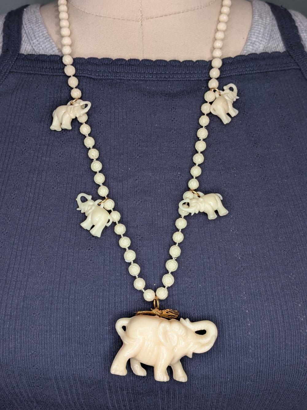 Vintage Molded Faux Ivory Plastic Elephant Charm Necklace Carved Floral Beads